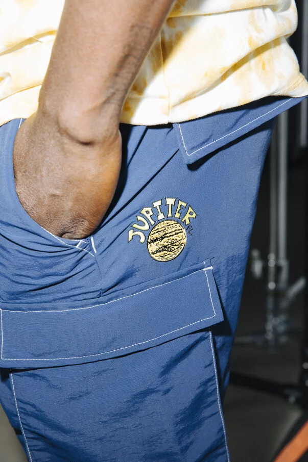 Close up shot of the logo on a pair of blue shorts from the Zion Wright signature collection.